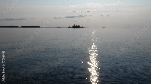 Slow motion travel by boat. Big freshwater lake. Sun reflections & Islands. Lake Nipissing, Ontario, Canada. photo