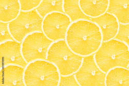 Lemon slices background. Yellow fruit cut texture. Citrus section pattern. Vibrant color summer design. Flat design backdrop.
