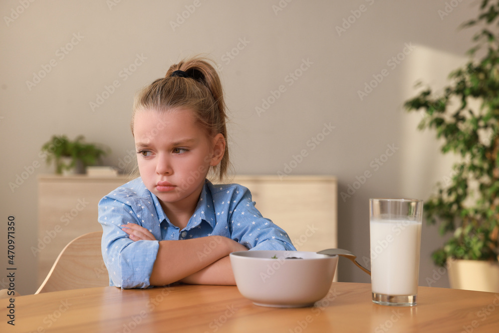 Cute little girl refusing to eat her breakfast at home Cute little girl refusing to eat her breakfast at home