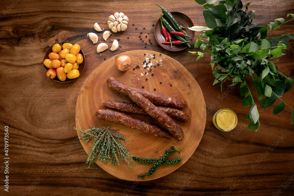 Fototapeta premium spanish chorizo sausages on rustic wood table with natural ingredients