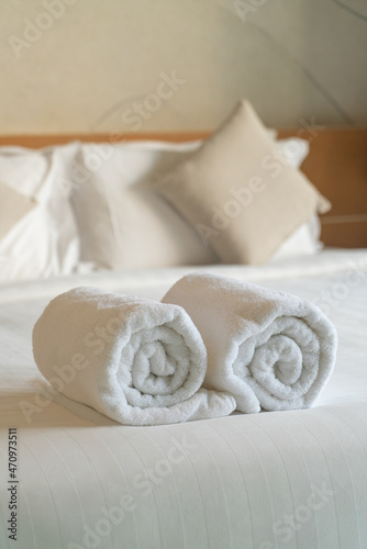 white towel on bed in bedroom