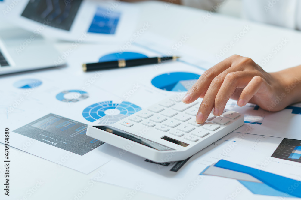 Business accounting concept, Business man using calculator with computer laptop, budget and loan paper in office. Business accounting concept, Business man using calculator with computer laptop, budget and loan paper in office.