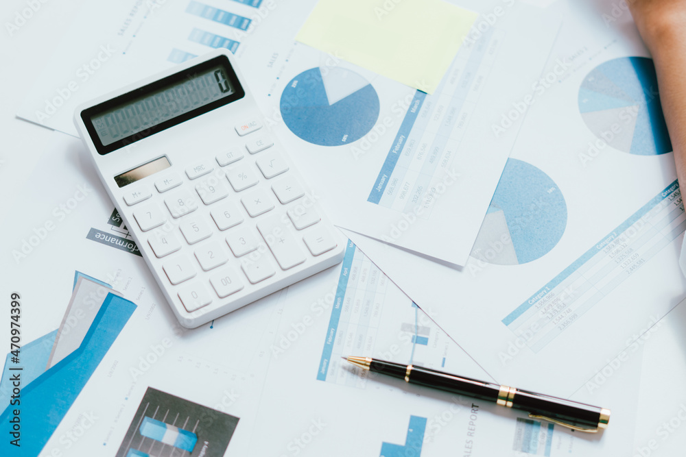 Business graph, sales report, calculator, pen ,Financial and Accounting concept. Business graph, sales report, calculator, pen ,Financial and Accounting concept.