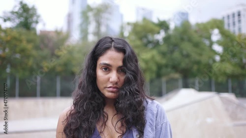Portrait of young mixed race millennial girl in New York City. Urban modern student lifestyle, hipster fashion in NYC, skater model, multi-ethnic hispanic American. skateboarder hipster at skatepark.