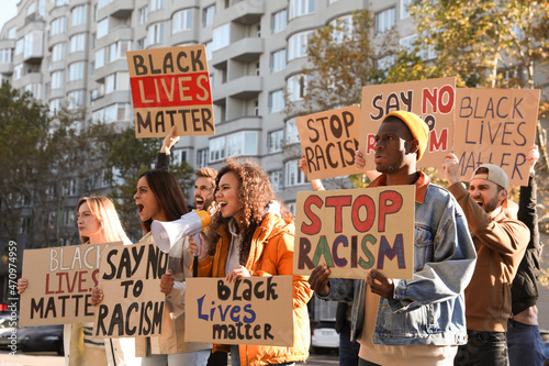 Photos Protesters demonstrating different anti racism slogans outdoors