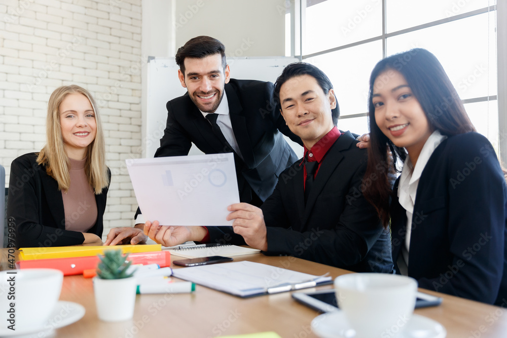 Cheerful multiethnic colleagues doing paperwork Cheerful multiethnic colleagues doing paperwork