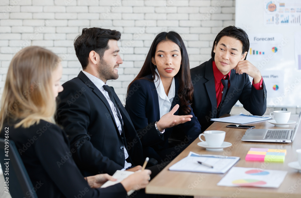 Cheerful multiethnic colleagues at table in boardroom Cheerful multiethnic colleagues at table in boardroom