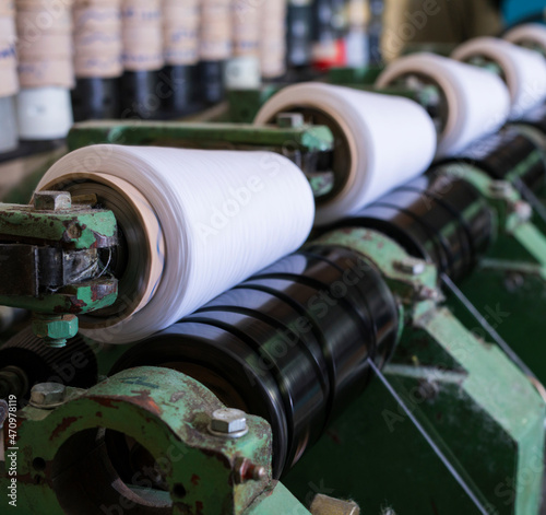 Spools with thread at rewinding machine view