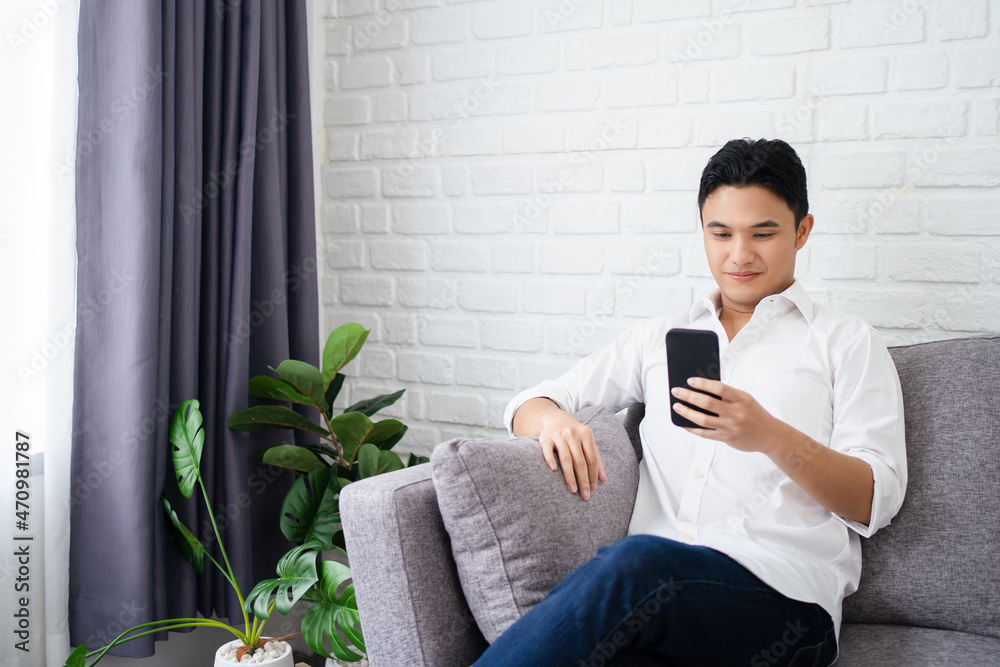 Excited smiling man looking at phone screen, using mobile app, typing message in social network, reading news, email. Excited smiling man looking at phone screen, using mobile app, typing message in social network, reading news, email.