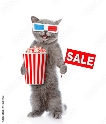 Happy cat wearing 3d glasses holds basket of popcorn and sales symbol. isolated on white background
