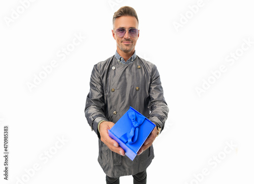 Fotografie Happy caucasian guy in trenchcoat give present gift box isolated on white, givin