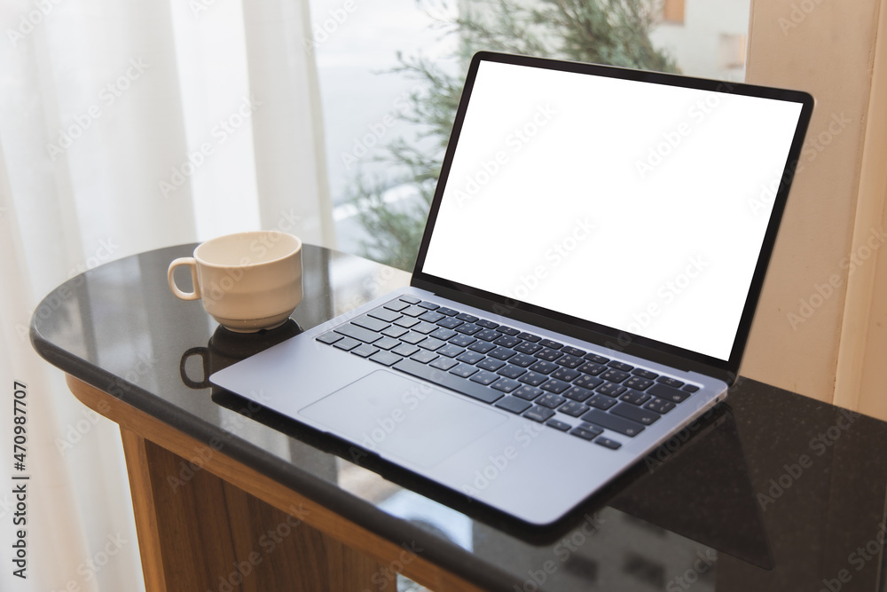 Blank screen laptop computer modern man use room laptop with blank white desktop screen with coffee cup on wooden table in cafe Blank screen laptop computer modern man use room laptop with blank white desktop screen with coffee cup on wooden table in cafe