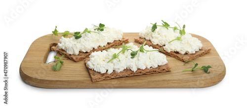 Crispy crackers with cottage cheese and microgreens on white background