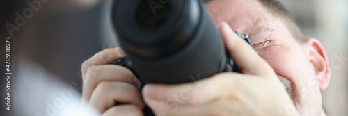 Man photographing woman using black professional camera