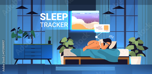 young woman sleeping in bed with electronic smart watch app tracker on hand quality and quantity sleep control