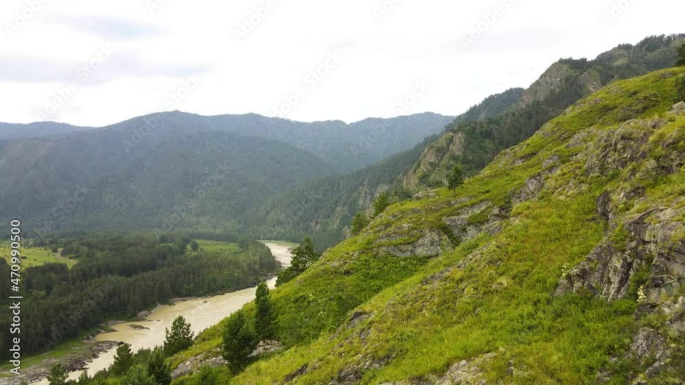 Mountain range against the backdrop of a summer landscape with a river Mountain range against the backdrop of a summer landscape with a river