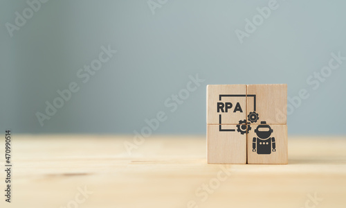 RPA Robotic process automation innovation technology concept. Wooden cube with Robot, Operating, and Artificial intelligence (AI) on grey background. Intelligent system automation, banner copy space