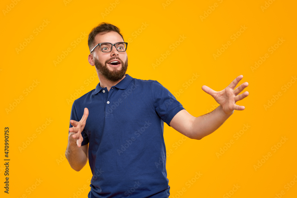 Amazed man in glasses pointing away in studio Amazed man in glasses pointing away in studio