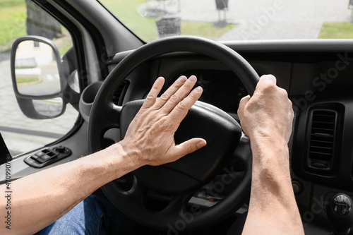 Mature man driving modern car