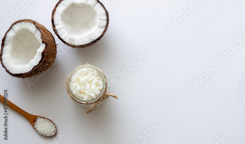 Coconut oil in a jar and fresh coconuts. Natural cosmetics.