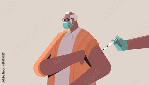 doctor hand vaccinating african american male patient in medical mask fight against coronavirus vaccine development