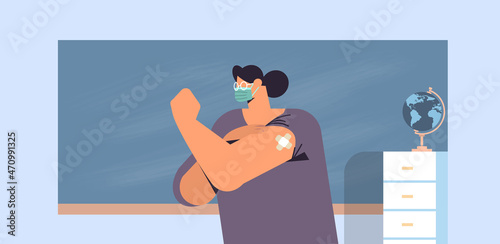vaccinated female teacher after vaccine injection successful covid-19 vaccination concept school classroom interior