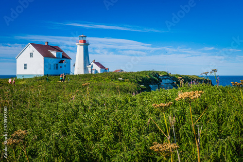 lighthouse and lighthouse keeper house on Ile aux Perroquets, one of Mingan archipelago island in Cote Nord region of Quebec (Canada) photo
