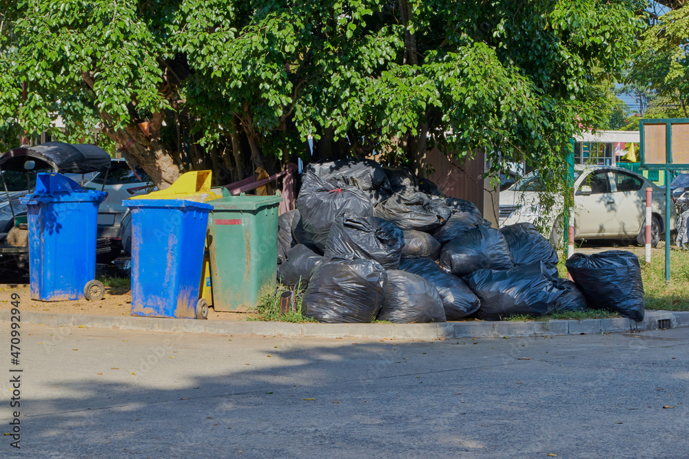 Junk and a pile of black garbage bags Junk and a pile of black garbage bags