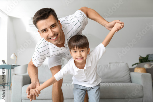 Man and his little son play...