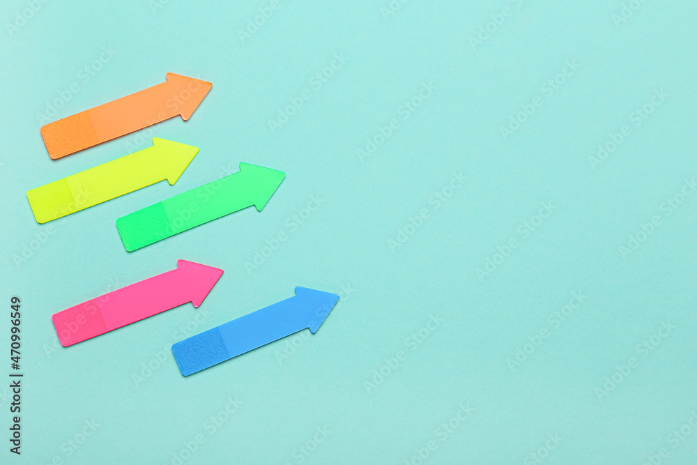 Sticky notes in shape of arrows on blue background