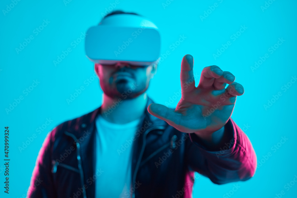 Man in VR goggles touching air in virtual reality Man in VR goggles touching air in virtual reality