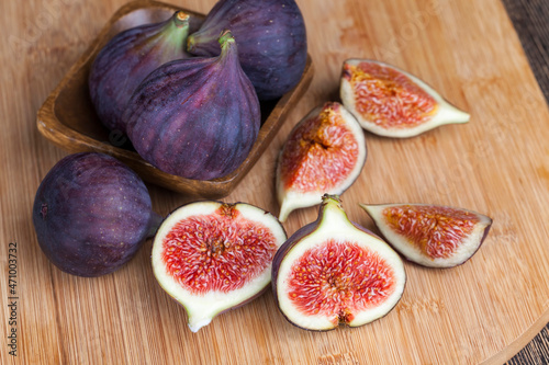 ripe purple figs on a wooden table