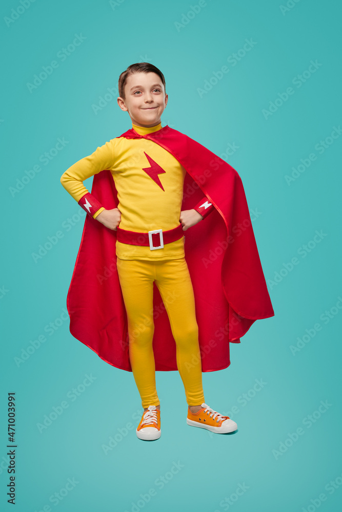 Confident superhero boy in costume in studio Confident superhero boy in costume in studio