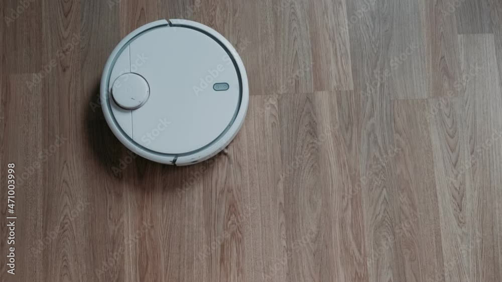 Vacuum Robot auto cleaning at home. Robot vacuum cleaner in the modern living room. Robot vacuum cleaner cleans the floor. Smart Home. Housekeeping.
Vacuum Robot auto cleaning at home. Robot vacuum cleaner in the modern living room. Robot vacuum cleaner cleans the floor. Smart Home. Housekeeping.