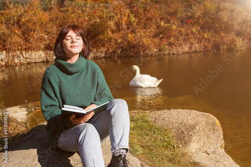 Young woman with books enjo...
