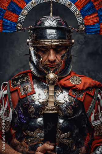 Imperial legionary with plumed helmet against dark background photo