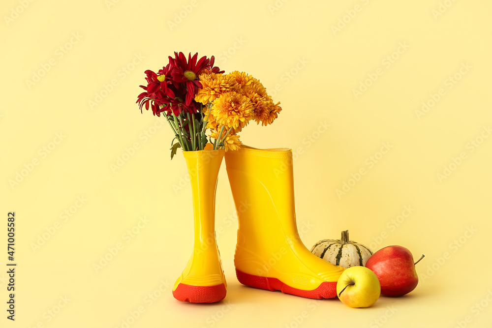 Rubber boots, flowers, pumpkin and apples on color background - obrazy, fototapety, plakaty 