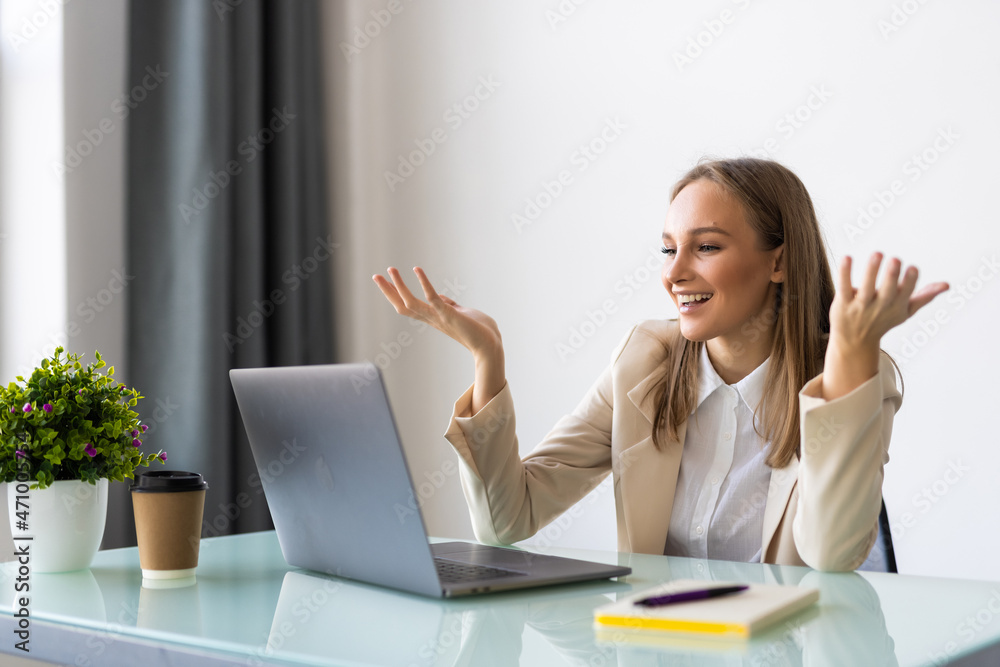 Attractive mad businesswoman in white blouse sitting at her workplace in office, looking at laptop screen with angry expression. Attractive mad businesswoman in white blouse sitting at her workplace in office, looking at laptop screen with angry expression.