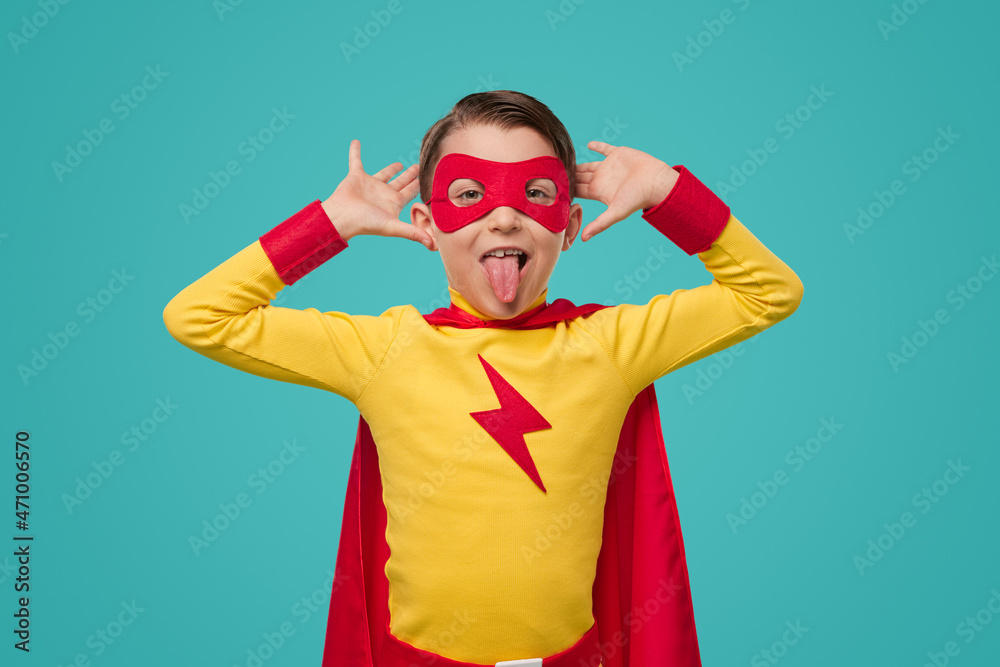 Fototapeta premium Funny boy in superhero costume making faces