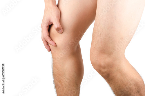 Knee pain. Young man's leg. He uses his hands to hold and massage the knee area. with tendon pain and knee joint muscles to relieve pain health concept
