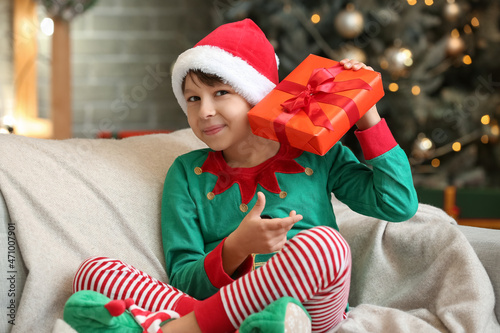 Cute little boy with gift a...