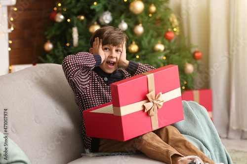 Surprised little boy openin...