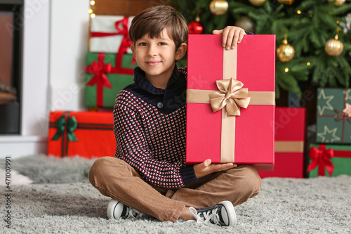Cute little boy with gift a...