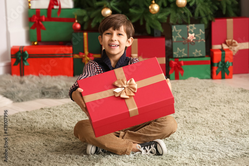 Cute little boy with gift a...