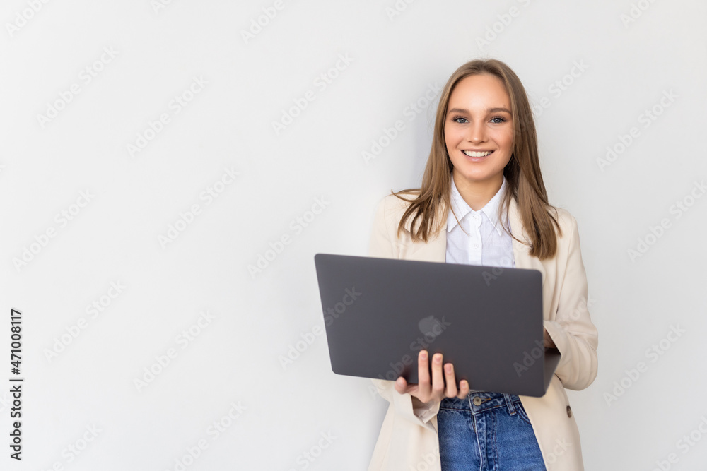 Portrait of a businesswoman holding laptop and looking away isolated over white background Portrait of a businesswoman holding laptop and looking away isolated over white background
