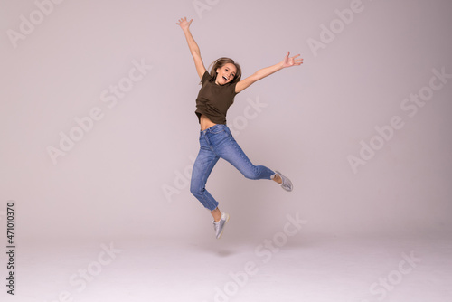 Portrait of a cheerful cute woman jumping on a white background