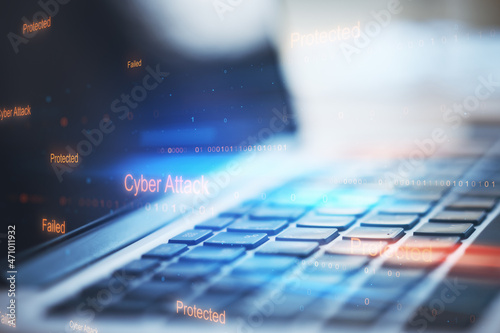 Close up of laptop with abstract binary code on blurry background. Cyber attack and hacking concept. Double exposure.