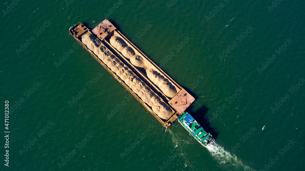 Tankship industrial sand and construction material carrier seen from a drone view.