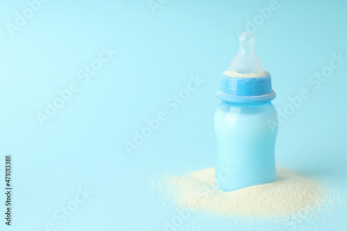 Concept of baby food with рowdered milk on blue background