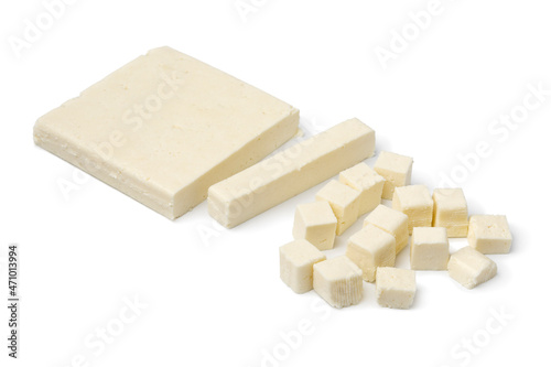 Slice of Indian paneer cheese and cuttings isolated on white background photo